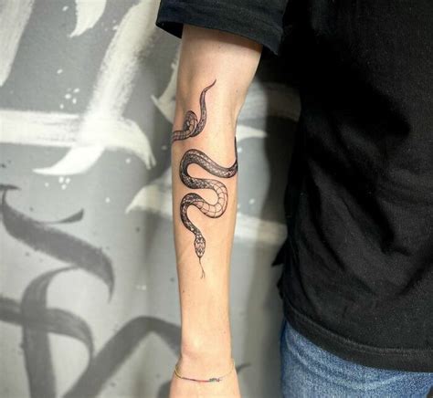 gucci snake bicep tattoo|snake tattoo around arm.